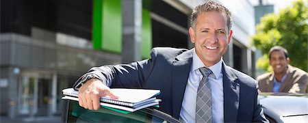 portrait two colleagues - Businessman climbing out of car Stock Photo - Premium Royalty-Free, Code: 6113-06753438