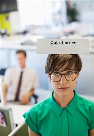 funny spectacles pictures - Businesswoman wearing 'out of order' sign Stock Photo - Premium Royalty-Free, Code: 6113-06753550