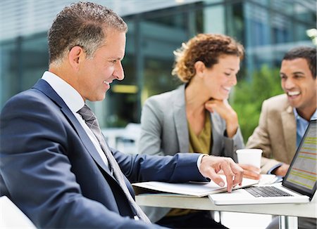 Business people talking outdoors Stock Photo - Premium Royalty-Free, Code: 6113-06753579