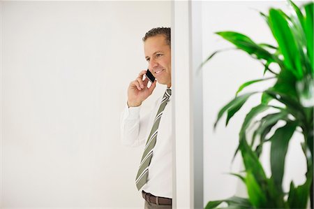 simsearch:6113-06753575,k - Businessman talking on cell phone Stock Photo - Premium Royalty-Free, Code: 6113-06753583