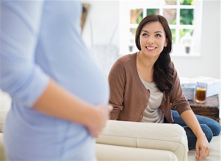 simsearch:6113-06753701,k - Woman smiling at pregnant friend Foto de stock - Royalty Free Premium, Número: 6113-06753640