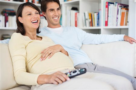 pregnant woman man - Couple watching television on sofa Stock Photo - Premium Royalty-Free, Code: 6113-06753649