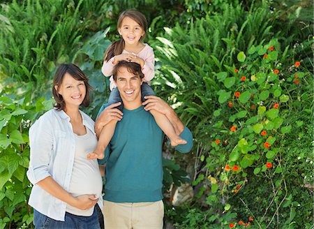 daughter riding on mother - Family smiling together outdoors Stock Photo - Premium Royalty-Free, Code: 6113-06753622