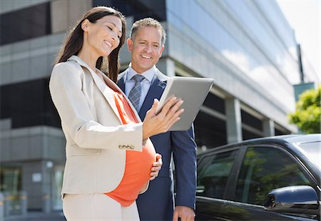 see city - Pregnant businesswoman and colleague using tablet computer Stock Photo - Premium Royalty-Free, Code: 6113-06753703