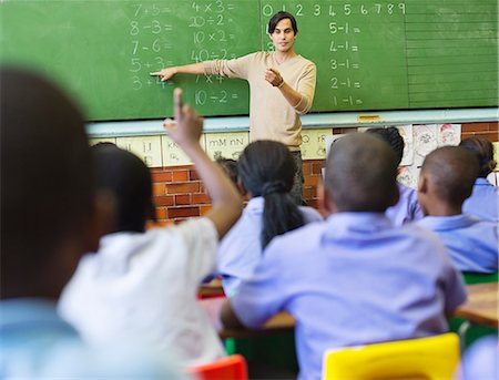 question and answer - Teacher talking to students at chalkboard Stock Photo - Premium Royalty-Free, Code: 6113-06753857