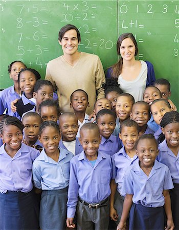 Students and teachers smiling in class Photographie de stock - Premium Libres de Droits, Code: 6113-06753877