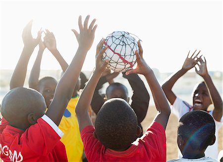 simsearch:6113-06753807,k - Boys playing soccer together in dirt field Stock Photo - Premium Royalty-Free, Code: 6113-06753805