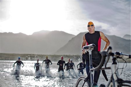 running woman race - Triathletes emerging from water Stock Photo - Premium Royalty-Free, Code: 6113-06754046