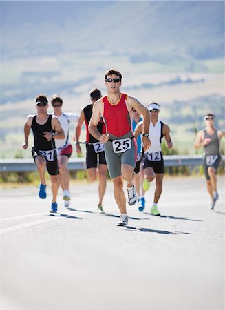 Runners in race on rural road Stock Photo - Premium Royalty-Free, Code: 6113-06754057