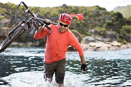 simsearch:6113-06754135,k - Man carrying mountain bike in river Stock Photo - Premium Royalty-Free, Code: 6113-06754092