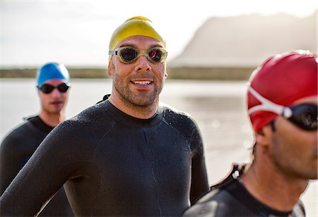 Triathletes in wetsuit smiling in water Photographie de stock - Premium Libres de Droits, Code: 6113-06754000