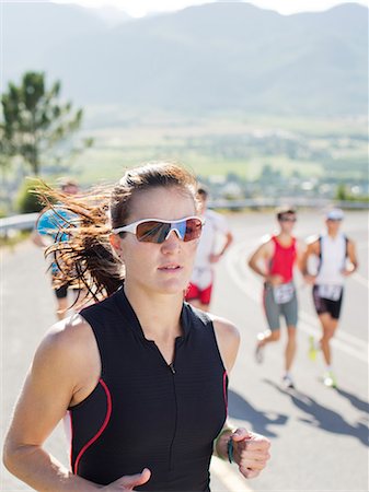 female triathlon - Runner in race on rural road Stock Photo - Premium Royalty-Free, Code: 6113-06754015