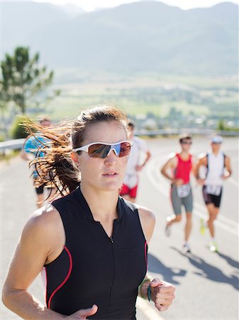 Runner in race on rural road Stock Photo - Premium Royalty-Free, Code: 6113-06754015