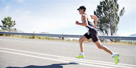 road race - Runner in race on rural road Stock Photo - Premium Royalty-Free, Code: 6113-06754021