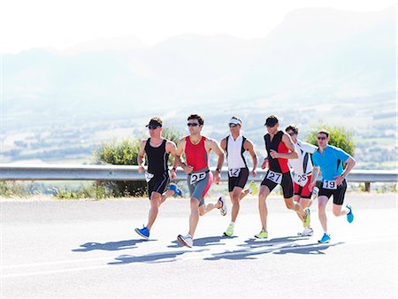 running road competitive - Runners in race on rural road Stock Photo - Premium Royalty-Free, Code: 6113-06754022