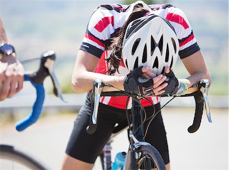 sport woman with helmet - Disappointed cyclist resting on handlebars Stock Photo - Premium Royalty-Free, Code: 6113-06754155