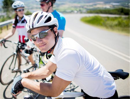 riding (vehicle) - Cyclist smiling on rural road Stock Photo - Premium Royalty-Free, Code: 6113-06754160