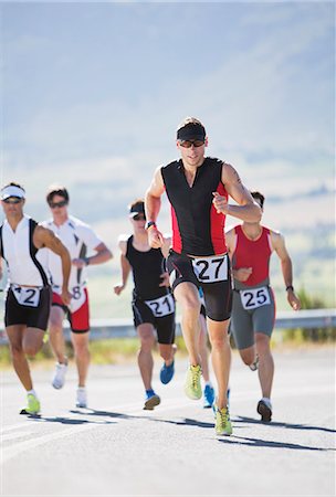 simsearch:6113-06754018,k - Runners in race on rural road Stock Photo - Premium Royalty-Free, Code: 6113-06754100