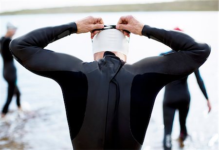 swimming - Triathlete adjusting goggles at start of race Stock Photo - Premium Royalty-Free, Code: 6113-06754119
