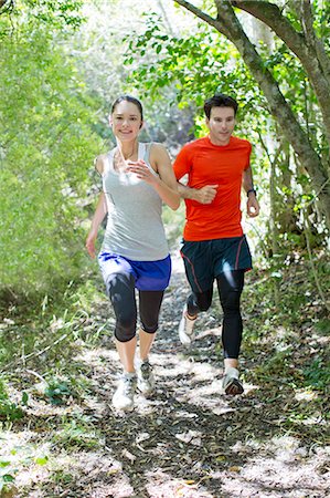 Couple running on dirt path Stock Photo - Premium Royalty-Free, Code: 6113-06754128