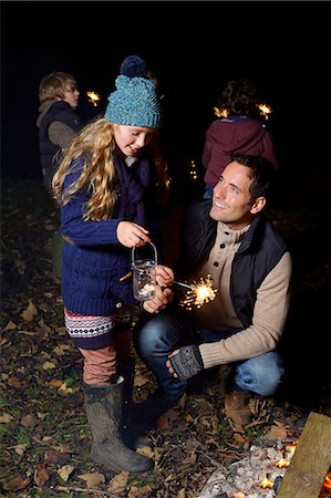fireworks kids photography - Father and daughter playing with sparkler Stock Photo - Premium Royalty-Free, Code: 6113-06720245
