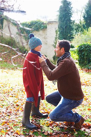 father helping boy image - Father tying son's scarf outdoors Stock Photo - Premium Royalty-Free, Code: 6113-06720220