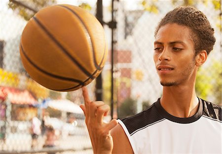 simsearch:6113-06720352,k - Man spinning basketball on finger Stock Photo - Premium Royalty-Free, Code: 6113-06720385