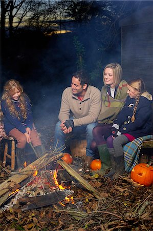 fall campfire - Family relaxing around campfire at night Stock Photo - Premium Royalty-Free, Code: 6113-06720318