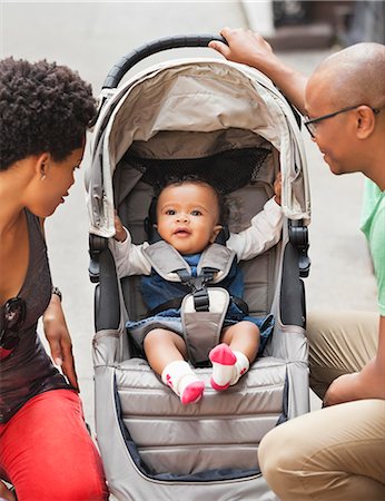 Parents with baby in stroller on city street Stock Photo - Premium Royalty-Free, Code: 6113-06720466