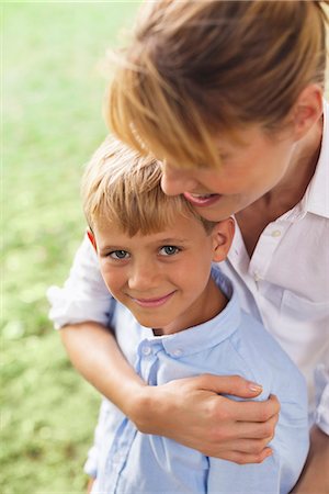 simsearch:6113-06909372,k - Mother hugging son in park Stock Photo - Premium Royalty-Free, Code: 6113-06720473