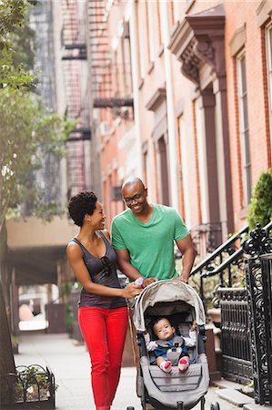 father mother kid outdoor happy infant - Family walking together on city street Stock Photo - Premium Royalty-Free, Code: 6113-06720472