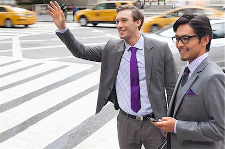 picture of someone hailing a taxi - Businessmen hailing taxi on city street Stock Photo - Premium Royalty-Free, Code: 6113-06720541