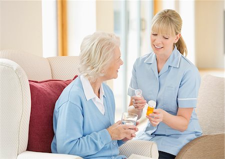 senior at home with medication - Caregiver talking with older woman Stock Photo - Premium Royalty-Free, Code: 6113-06720586