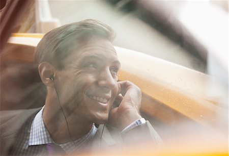 simsearch:6113-07961631,k - Businessman talking on cell phone in taxi Stock Photo - Premium Royalty-Free, Code: 6113-06720500