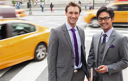 Businessmen smiling on city street Photographie de stock - Premium Libres de Droits, Code: 6113-06720501