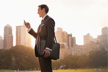 parks city - Businessman using cell phone in urban park Stock Photo - Premium Royalty-Free, Code: 6113-06720507