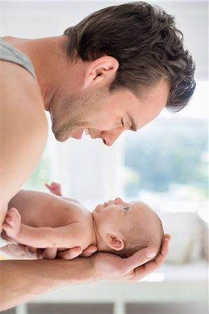 simsearch:6113-06720633,k - Father cradling newborn baby Photographie de stock - Premium Libres de Droits, Code: 6113-06720642