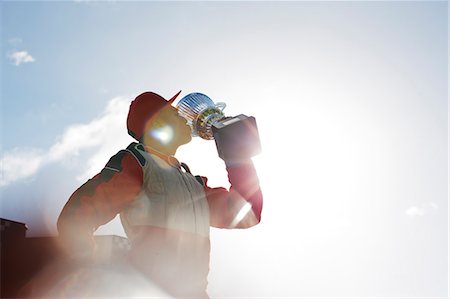 Racer kissing trophy on track Stock Photo - Premium Royalty-Free, Code: 6113-06720768