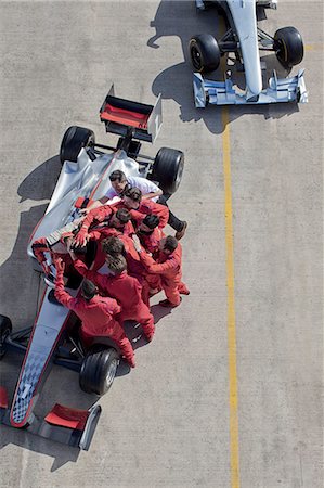 race car overhead - Race team surrounding racer on track Stock Photo - Premium Royalty-Free, Code: 6113-06720772