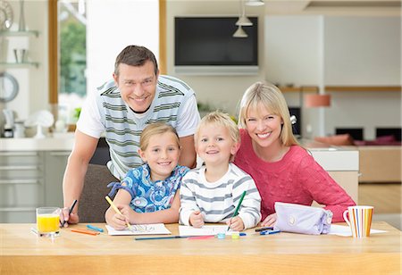 Family smiling together at table Stock Photo - Premium Royalty-Free, Code: 6113-06720701
