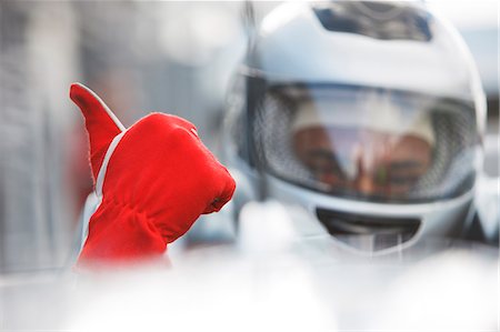 drivers uniforms males - Racer giving thumbs up in car Stock Photo - Premium Royalty-Free, Code: 6113-06720736