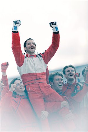 Racer and team cheering on track Stock Photo - Premium Royalty-Free, Code: 6113-06720855