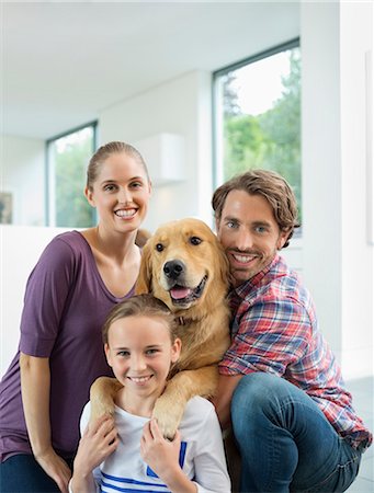 simsearch:6113-06720990,k - Family smiling with dog indoors Stock Photo - Premium Royalty-Free, Code: 6113-06720981