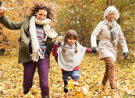 Three generations of women playing in autumn leaves Stock Photo - Premium Royalty-Free, Code: 6113-06721140