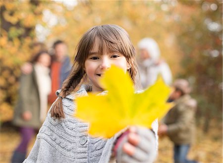 fall, season - Girl holding autumn leaf in park Stock Photo - Premium Royalty-Free, Code: 6113-06721153