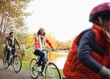 park lane - Family riding bicycles together in park Stock Photo - Premium Royalty-Free, Code: 6113-06721176