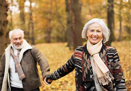 senior woman autumn - Older couple walking together in park Stock Photo - Premium Royalty-Free, Code: 6113-06721190