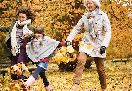 family outdoor walking and grandparents - Three generations of women playing in autumn leaves Stock Photo - Premium Royalty-Free, Code: 6113-06721198