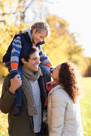 shoulder ride on mom - Family smiling together in park Stock Photo - Premium Royalty-Free, Code: 6113-06721199