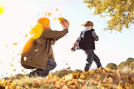 father son caucasian walking two people casual clothing - Father and son playing in autumn leaves Stock Photo - Premium Royalty-Free, Code: 6113-06721135